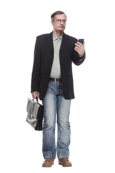 in full growth. serious business man with a smartphone. - Foto, imagen