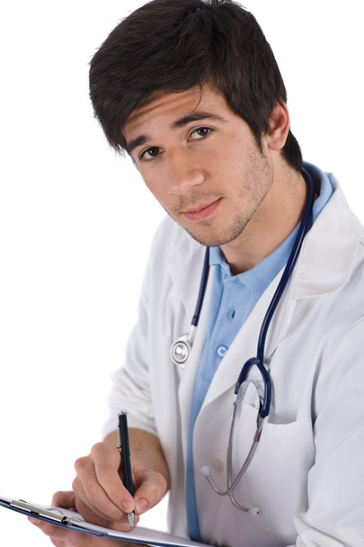 Male student doctor with stethoscope writing on white background - Fotoğraf, Görsel