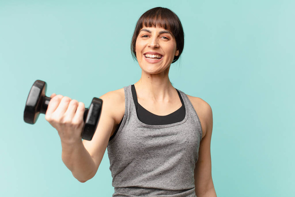 young fitness woman with a dumbbell - Zdjęcie, obraz