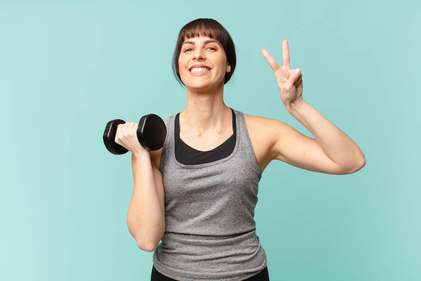 young fitness woman with a dumbbell - Φωτογραφία, εικόνα