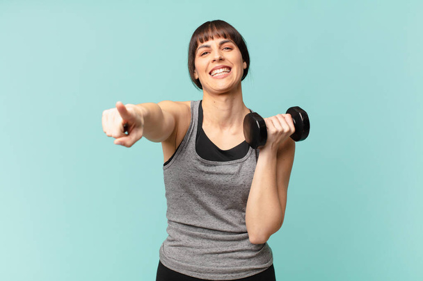 young fitness woman with a dumbbell - Fotografie, Obrázek