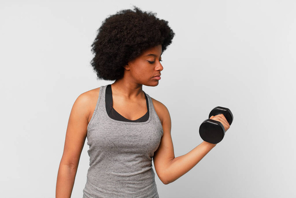 black afro fitness woman with a dumbbell - Фото, зображення
