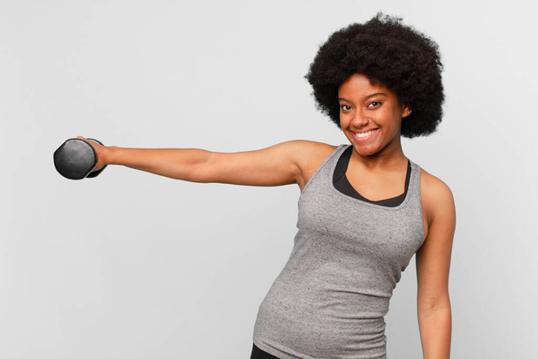 black afro fitness woman with a dumbbell - Valokuva, kuva