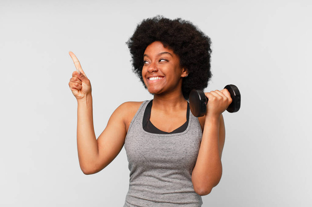 black afro fitness woman with a dumbbell - Fotoğraf, Görsel