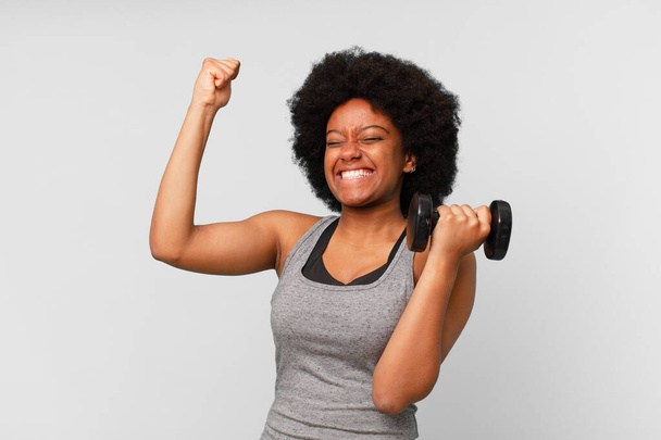 black afro fitness woman with a dumbbell - Foto, imagen