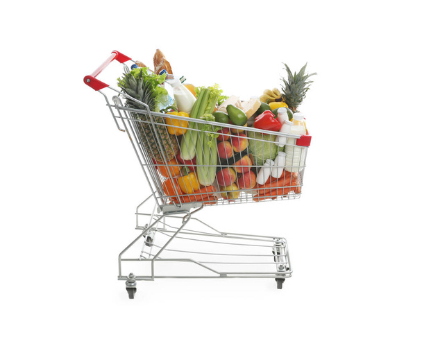 Shopping cart with groceries on white background - Фото, зображення