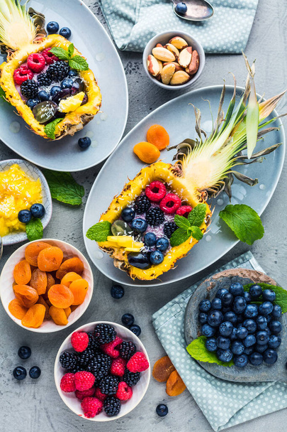 top view of fresh ripe pineapple and berries on table   - Photo, Image