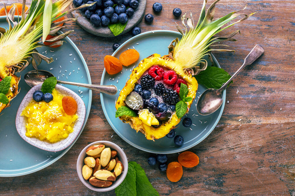 top view of tasty dessert with fresh ripe pineapple and berries on table   - Photo, Image