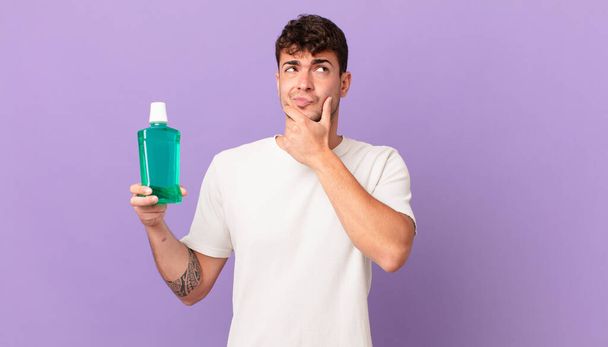 man with mouthwash thinking, feeling doubtful and confused, with different options, wondering which decision to make - Φωτογραφία, εικόνα