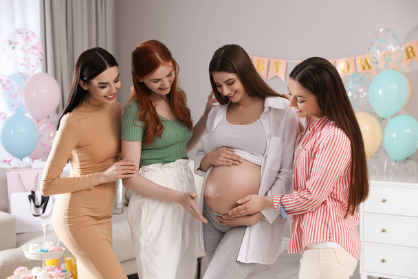 Happy pregnant woman spending time with friends at baby shower party - Foto, Bild