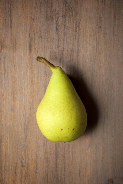 Close-up of a pear on a wooden table. - Photo, Image