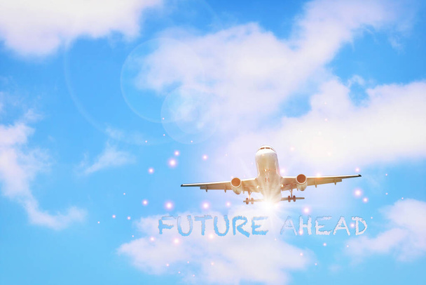 Future ahead word and commercial plane on beautiful blue sky background with fluffy cloud. Transportation concept and airplane business recovery idea - Photo, Image