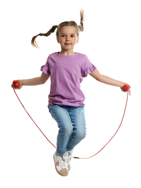Cute little girl with jump rope on white background - Фото, изображение