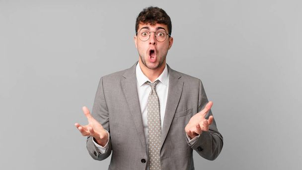 businessman open-mouthed and amazed, shocked and astonished with an unbelievable surprise - Photo, Image