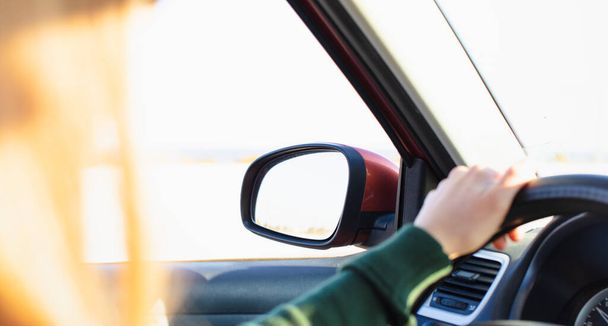 Woman holding steering wheel and driving - 写真・画像
