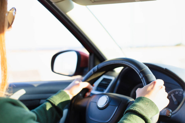 Woman holding steering wheel and driving - Фото, зображення