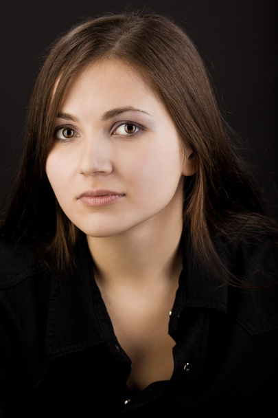 Young unhappy woman in black shirt look at you - Фото, изображение