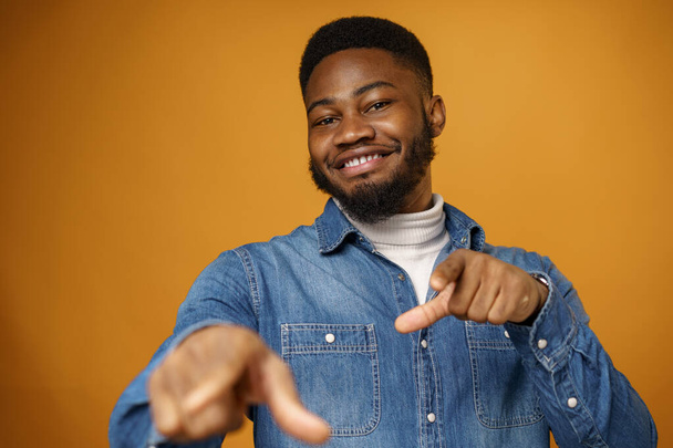 Young african american man wearing casual clothes pointing at you against yellow background - Фото, изображение