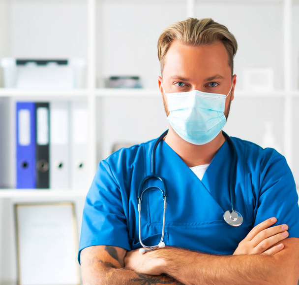 Professional medical doctor in hospital office, Portrait of young and confident physician in protective mask. - Φωτογραφία, εικόνα