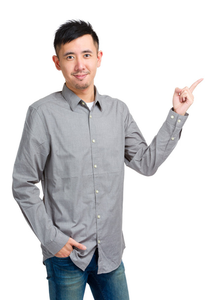 Asian young man pointing aside - Photo, Image