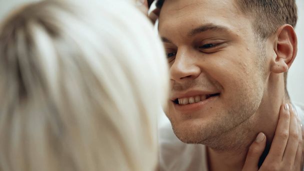 close up of happy man hugging with girlfriend on blurred foreground  - Photo, Image
