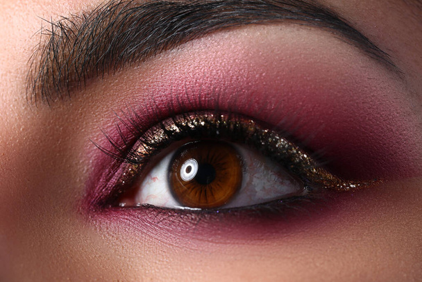 Female eye with eyebrows and makeup in pink shades - Photo, Image