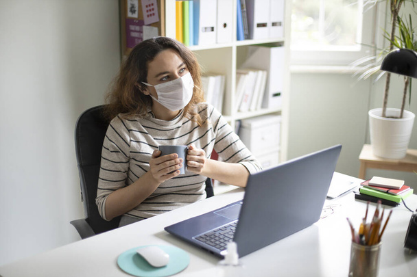 Young woman working from home after coronavirus pandemic - Fotó, kép