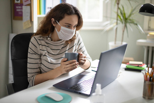 Young woman working from home after coronavirus pandemic - 写真・画像