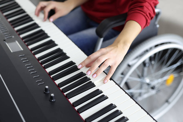 Femme en fauteuil roulant jouant synthétiseur tout en faisant de la musique - Photo, image