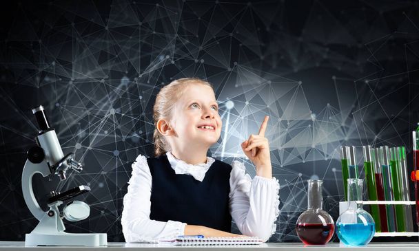 Little girl scientist sitting at desk - Valokuva, kuva