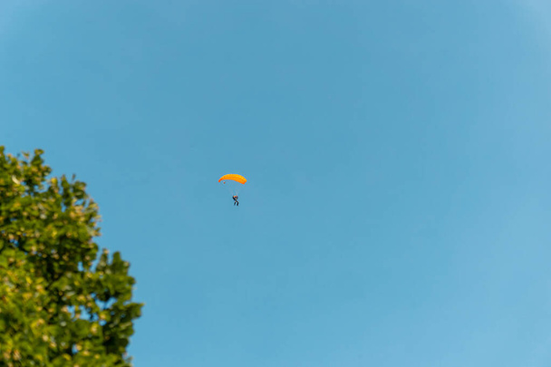 KECSKEMET, HUNGARY - Jun 13, 2020: A distant shot of a skydiving male - Photo, Image