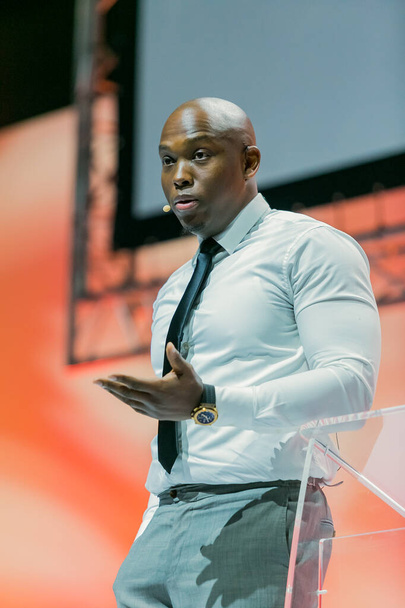 JOHANNESBURG, SOUTH AFRICA - Mar 11, 2021: Johannesburg, South Africa - August 21, 2018: Entrepreneur and speaker Vusi Thembekwayo live on stage at Think Sales Convention - Zdjęcie, obraz