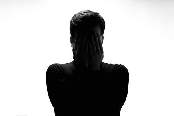 Silhouette of man crying being sad having depression - Fotografie, Obrázek