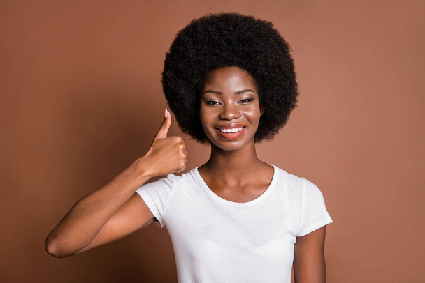 Portrait of cheerful charming dark skin lady show thumb up toothy smile isolated on brown color background - Photo, image