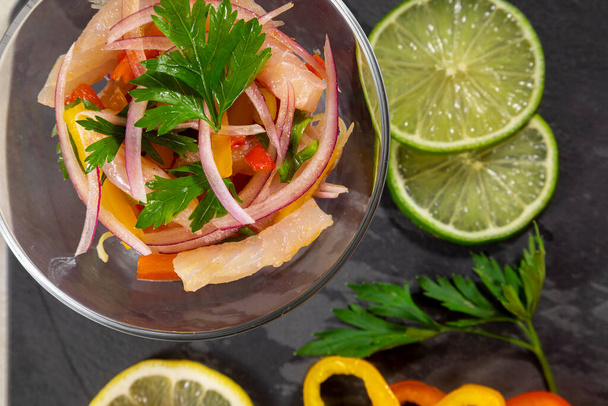 Peruvian ceviche is a traditional dish consumed in Peru. The preparation method is different from other places, using lemon, fish, potatoes, onion, seaweed, corn, chili, ginger, milk, sweet potato. - Photo, Image