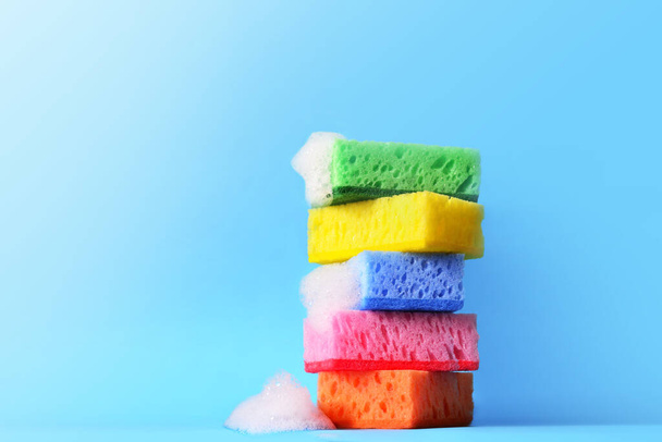 sponges cleaning kit isolated on blue background and foam - Photo, Image