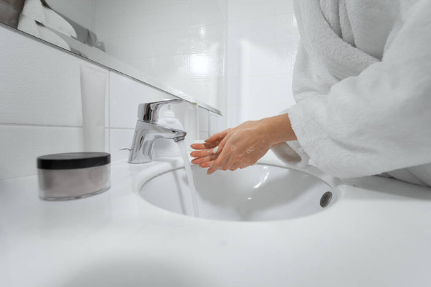 Washing hands with antibacterial soap in bathroom.  - Foto, Bild