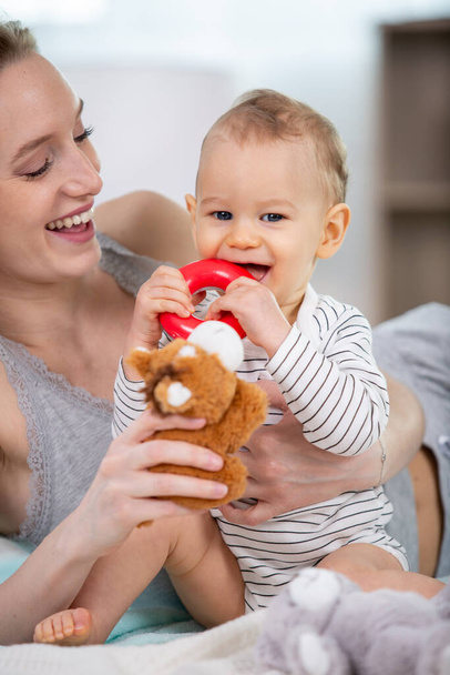 baby child and her mommy play with toys at home - Foto, Bild
