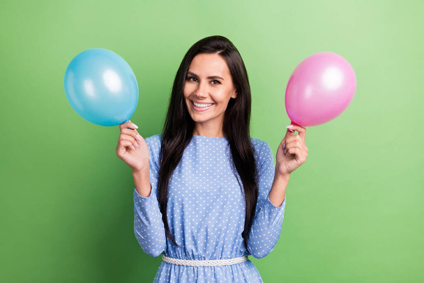 Photo of funny brown hair lady hold balloons wear blue dress isolated on green color background - Fotografie, Obrázek