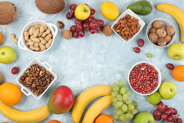 Fresh summer tropical fruits and nuts assortment on a bright sunny table, citrus mix, detox diet and weight loss concepts, banner, advertising for a store, healthy and natural food, - Photo, Image