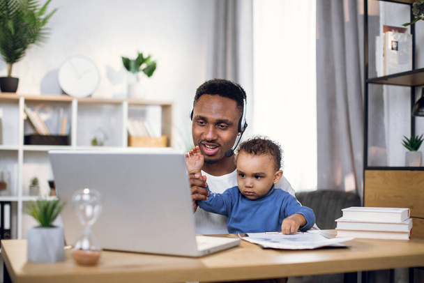 Afro man having video chat and taking care of son - Φωτογραφία, εικόνα