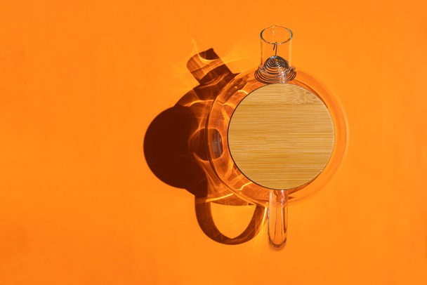glass teapot with a hard shadow on a colored background - Photo, Image