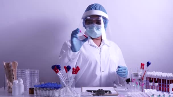 Chemists mixed up blood and chemical test for Covid 19 antibodies. Drugs and vaccine research at the hospital laboratory. Experiment to detect virus in the blood. Coronavirus vaccine development. - Materiaali, video
