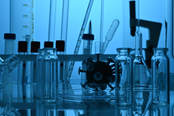 Covid Virus Model Among Chemical Glassware Lab Equipment - Fotografie, Obrázek