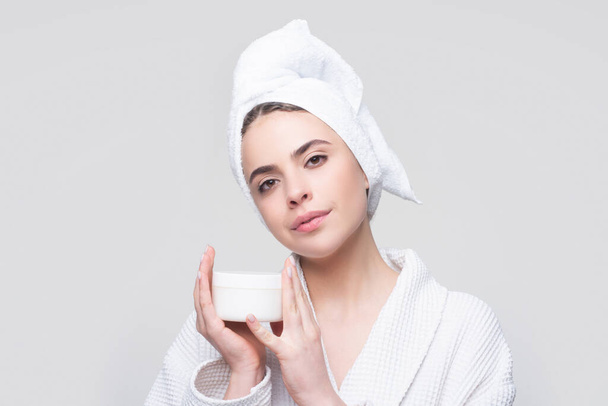 Face beauty care. Portrait of beautiful woman with facial cream in hand. Sexy female with fresh clean soft skin. Cosmetic skincare product. - Foto, imagen