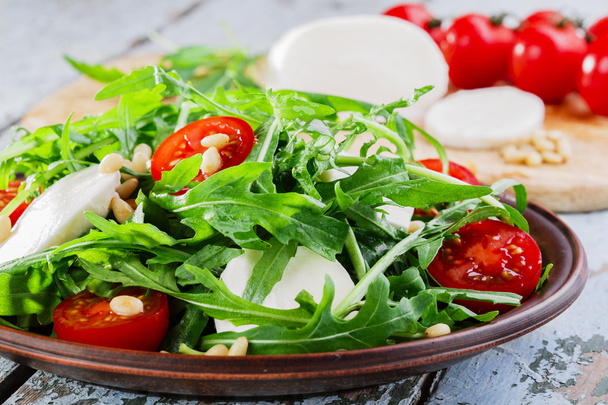 Arugula salad with mozzarella cheese and cherry tomatoes - Photo, Image