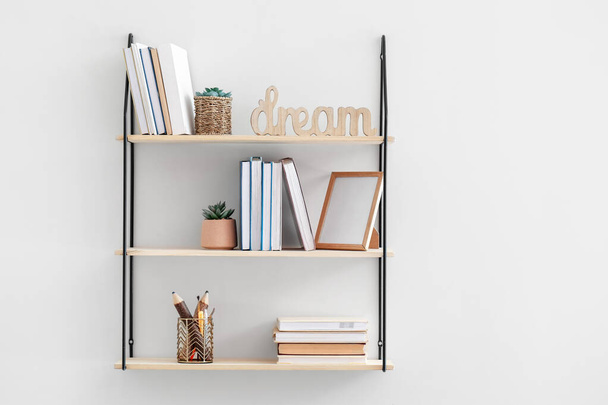 Stylish shelf hanging on light wall - Photo, Image