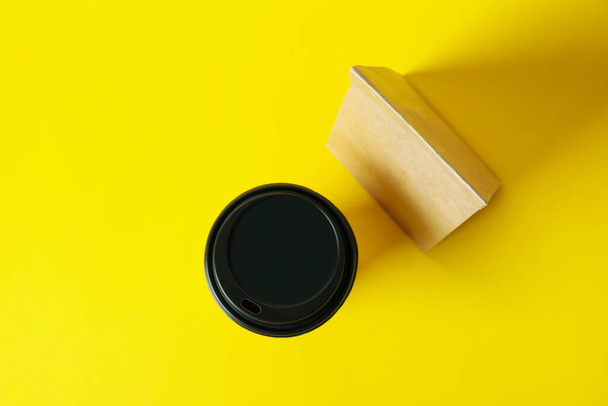 Paper cup and paper bag on yellow background - Photo, Image