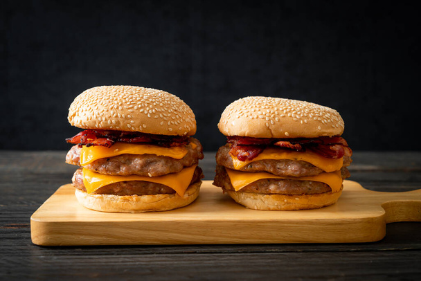 pork hamburger or pork burger with cheese and bacon - Фото, зображення