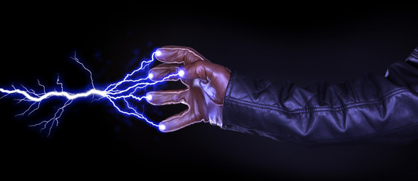Hand shooting out a bolt of lightning - Dark and mysterious, isolated on black - Photo, Image